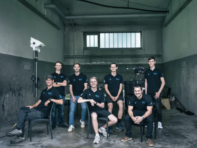 The HERMES team gathered with their research UAVs at the competition venue.